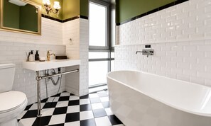 A bathroom with a white bathtub, a sink, and a toilet. - 648 Hotel (Seoul)