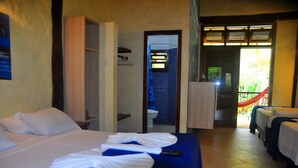 Quarto de hotel com cama, banheiro e varanda.