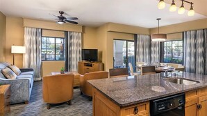 A hotel room with a living area, dining space, and kitchen. - Phoenix | Desert Golf Retreat | Pool, Dining & Sunsets (Phoenix)