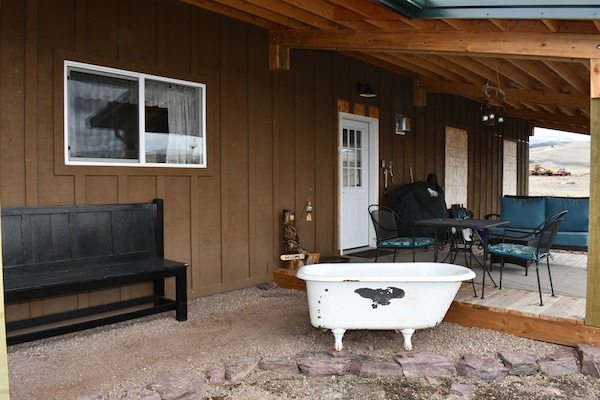 View of guest porch and entrance, pellet grill and utensils for our guests.