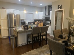 Prepare meals in the fully equipped kitchen with an island and dining area.