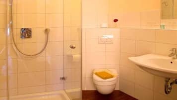 Shower, hair dryer, soap, toilet paper