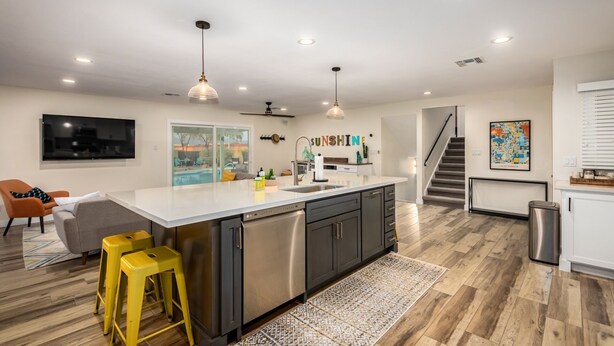 A modern kitchen with a large island, stainless steel appliances, and pendant lighting. - *Heated Pool Available* | South Scottsdale Paradise (Scottsdale)