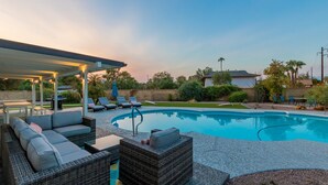A swimming pool with lounge chairs and a covered patio area. - *Heated Pool Available* | South Scottsdale Paradise (Scottsdale)