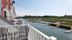 A balcony with a view of a marina with docks and boats.