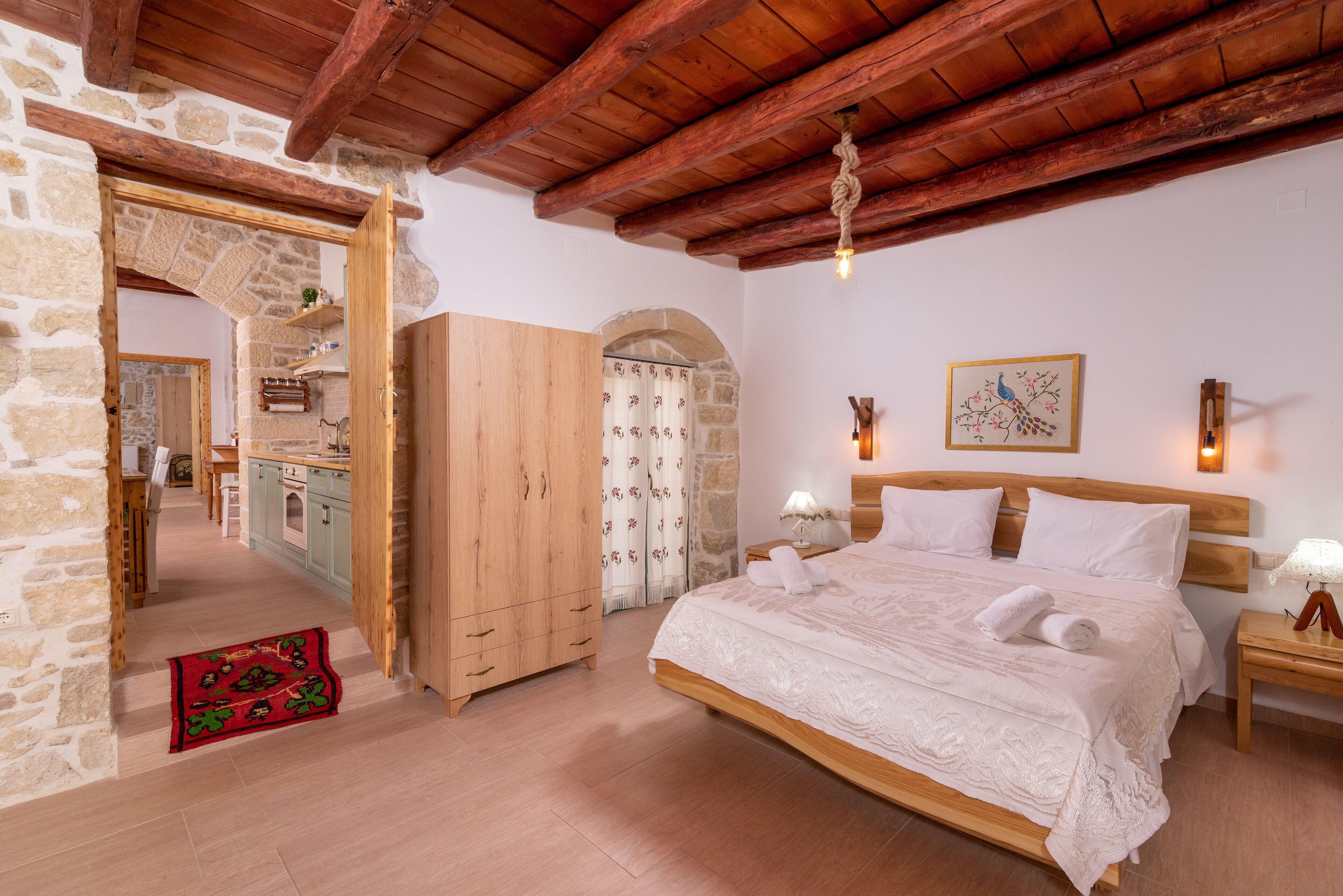 A bedroom with a wooden bed, stone walls, and a wooden ceiling.