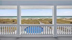 A covered balcony with a view of the ocean and beach. - Sea2Sky by Carolina Getaway - Oceanfront Home w/ Private Pool & Heated Spa (Kure Beach)