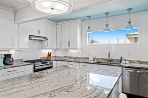 Fridge, microwave, oven, stovetop - Sea2Sky by Carolina Getaway - Oceanfront Home w/ Private Pool & Heated Spa (Kure Beach)