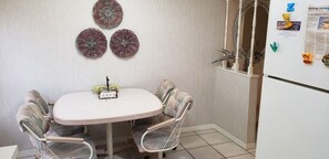 Enjoy a simple meal at the kitchen table with two chairs.