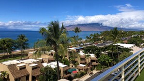 A resort with multiple buildings, a pool, and a view of the ocean and mountains. - Where Turquoise Waters Beckon Kihei Condo Ocean Views Rooftop Garden Pool (Kihei)