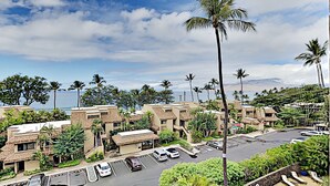 A resort with multiple buildings, a parking lot, and a pool area. - Where Turquoise Waters Beckon Kihei Condo Ocean Views Rooftop Garden Pool (Kihei)