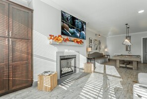 Smart TV, fireplace, books, computer monitors