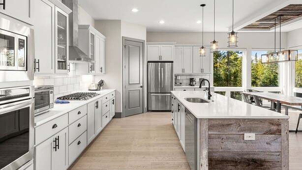 A modern kitchen with white cabinetry, stainless steel appliances, and a large island. - Luxury|Views|Hot Tub|Free Bus Route (Breckenridge)