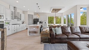 A modern kitchen with white cabinets, a central island, and pendant lighting. - Luxury|Views|Hot Tub|Free Bus Route (Breckenridge)