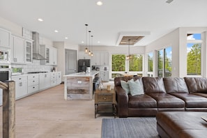 A modern kitchen with white cabinets, a central island, and pendant lighting. - Luxury|Views|Hot Tub|Free Bus Route (Breckenridge)