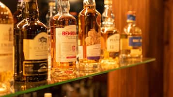 A variety of spirits displayed on a shelf.