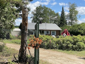 Exterior front with Garden and propane Fireplace