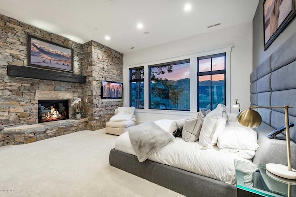 main master with view of Deer Valley Empire Pass with TV and easy gas fireplace.