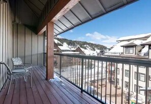 Enjoy breathtaking views of the surrounding landscape from this balcony.