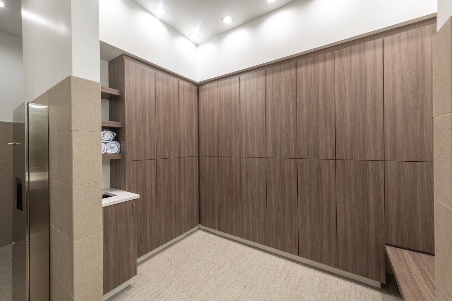 A modern bathroom with a built-in shower, a toilet, and a sink.