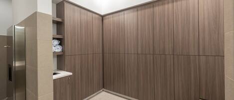A modern bathroom with a built-in shower, a toilet, and a sink.