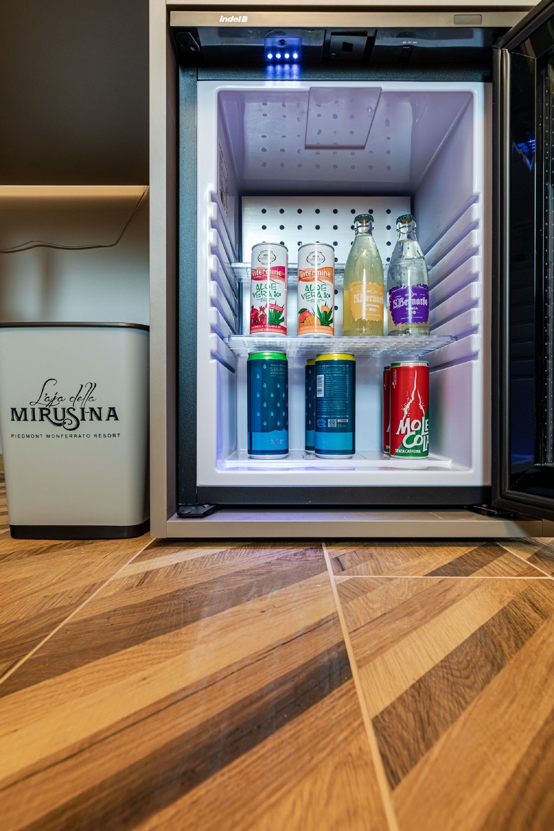 A minibar with various beverages and cans.