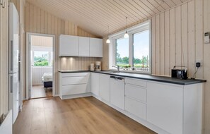 Fridge, stovetop, dishwasher, coffee/tea maker