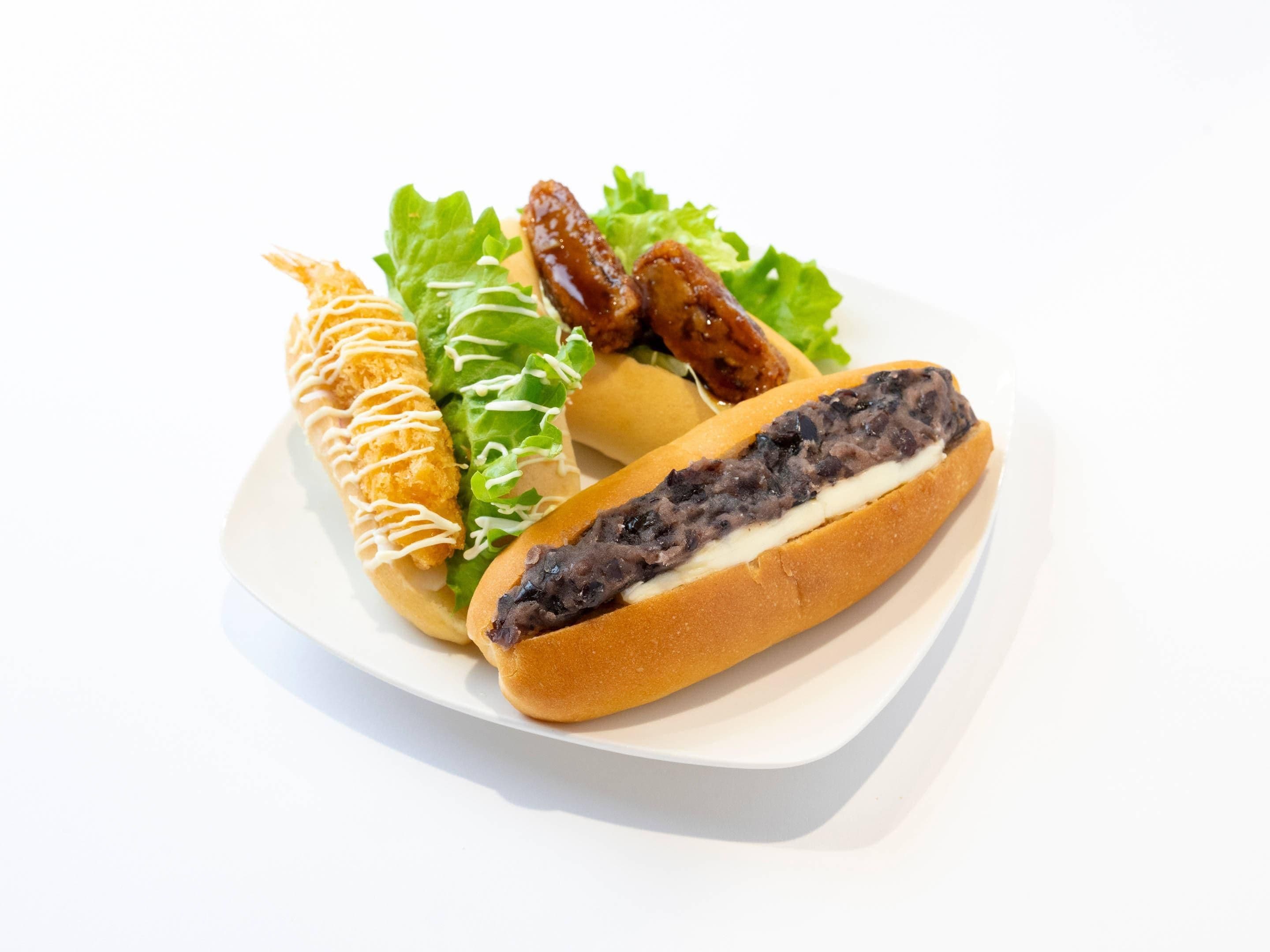 A plate with a sandwich, a fried item, and a salad.