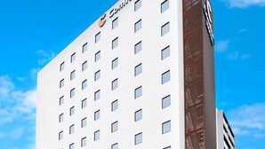 A hotel with a modern facade, multiple windows, and a prominent logo at the top. - Comfort Hotel ERA Nagoya Meiekiminami (Nagoya)