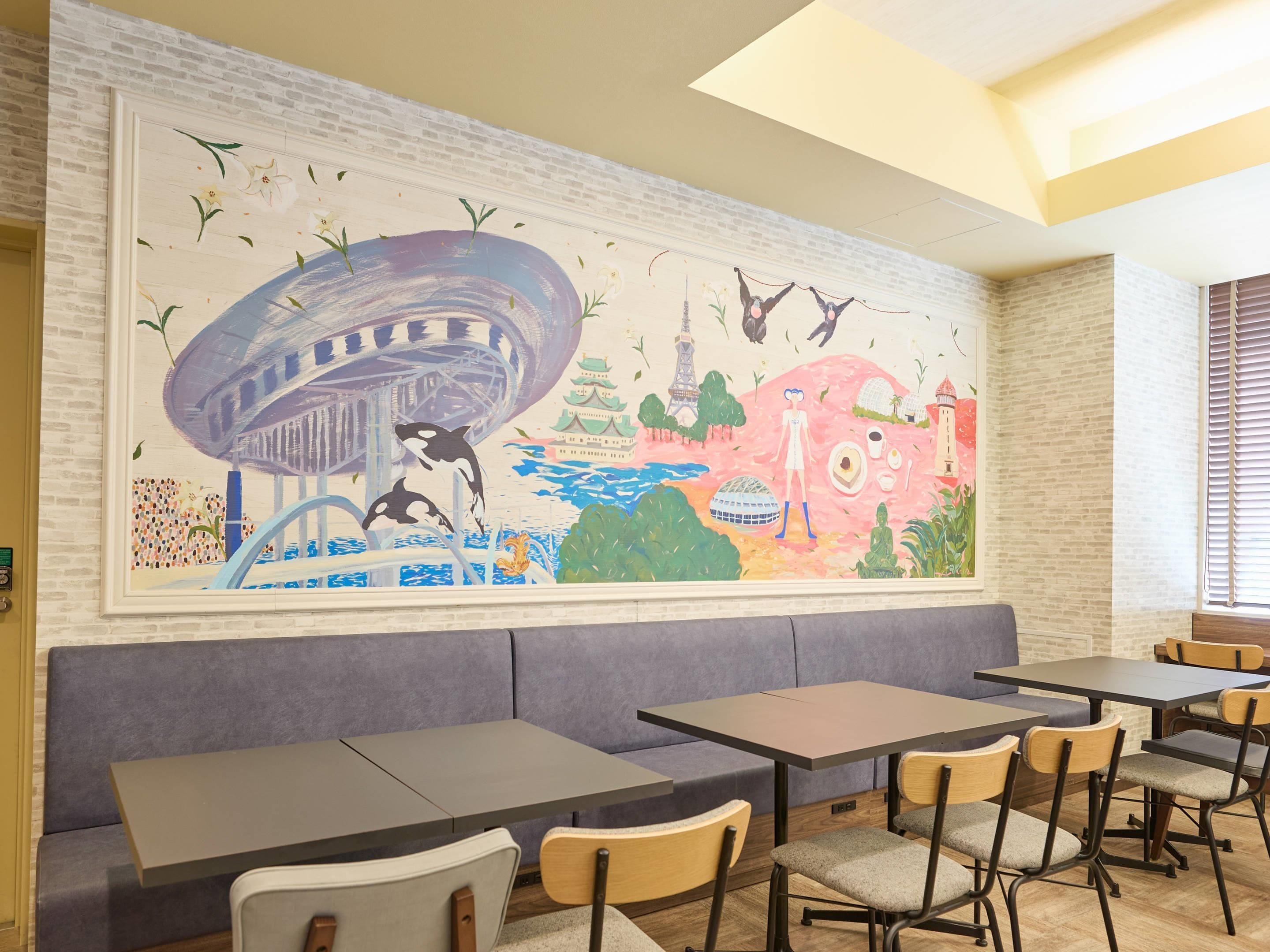 A restaurant with a mural, seating, and a brick wall.