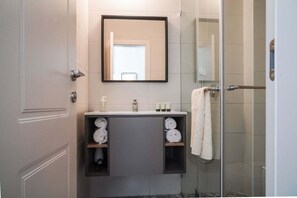 Shower, designer toiletries, hair dryer, towels