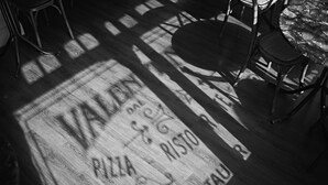 A restaurant floor with a patterned tile design and a table and chairs arrangement. - Valentinos Restaurant With Rooms (Ripon)