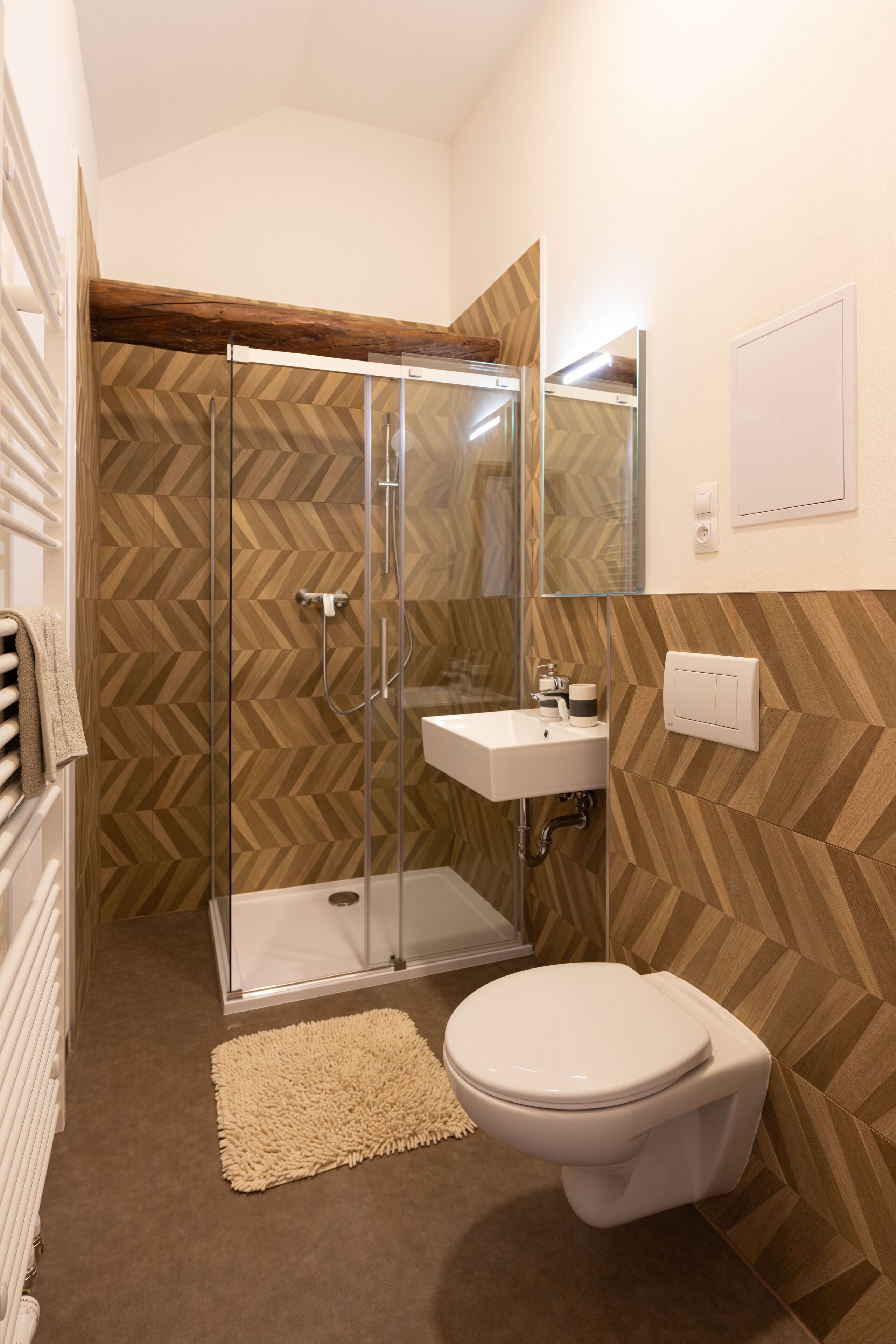 A bathroom with a shower, sink, and toilet.