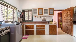 A kitchen with a built-in oven, a refrigerator, and a sink. - Rustic Pvt 2bhk Villa w/ Fiber Net - Dar AlSalaam (Pilar)
