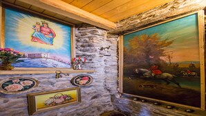 A stone wall with religious paintings and a wooden ceiling. - Terrazza Vista Menaggio (Plesio)