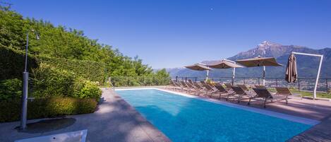 Piscine extérieure, parasols de plage, chaises longues