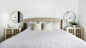 A neatly arranged bedroom with a large bed, two bedside tables with lamps, and a headboard. - Mountain View with Hot Tub/AC nestled in the pines  (Flagstaff)