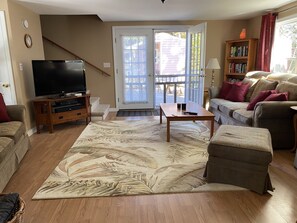 Relax in a cozy seating area with a comfortable sofa and armchair, perfect for unwinding and enjoying the view.