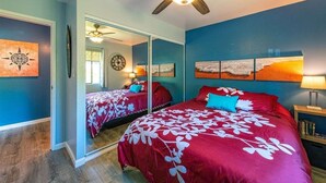 A bedroom with two beds, a ceiling fan, and artwork on the walls. - NEW! Modern 2bd/2ba Beach Retreat in Sunny South Kihei (Kihei)