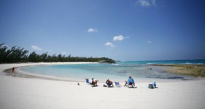 Home overlooking Gregory Town's famous Cove. Beach chairs and SUP included