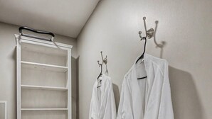 A bathroom with a white towel rack, a white towel rack, and a white towel rack.