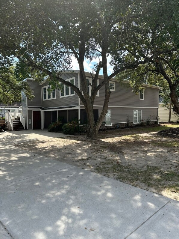 A two-story house with a covered front porch and a garage.