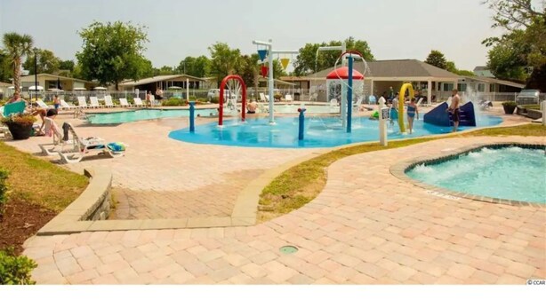 A water park with multiple pools, slides, and play structures. - Lower Level, Apartment Style Beach House! (Surfside Beach)