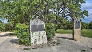 A weathered stone monument with inscriptions, surrounded by lush greenery and trees. - Pet-Friendly Canyon Lake Studio: Fish, Boat, Relax (Canyon Lake)