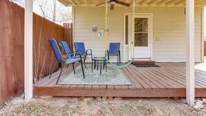 A covered porch with a swing chair, a small table, and two chairs. - Pet-Friendly Canyon Lake Studio: Fish, Boat, Relax (Canyon Lake)