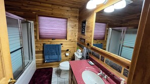 Combined shower/bathtub, towels, toilet paper
