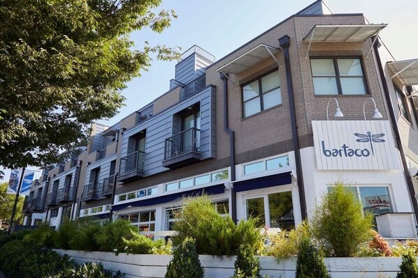 A multi-story building with a restaurant named 'bartaco' on the ground floor.