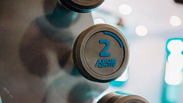 A close-up of a control panel with numbered buttons labeled "APUS Sports."