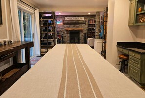 A room with a long table, a fireplace, bookshelves, and a sign reading 'SNOHOMISH, WA'.
