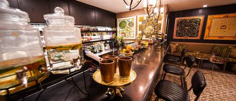 A bar area with a counter, stools, and a decorative centerpiece.